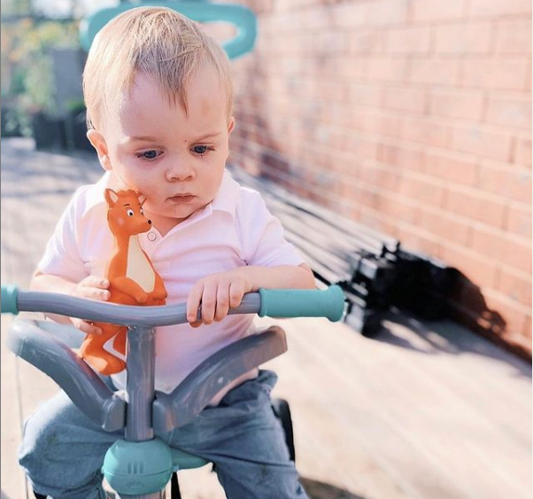 Kid riding a toddler bike with Mizzie