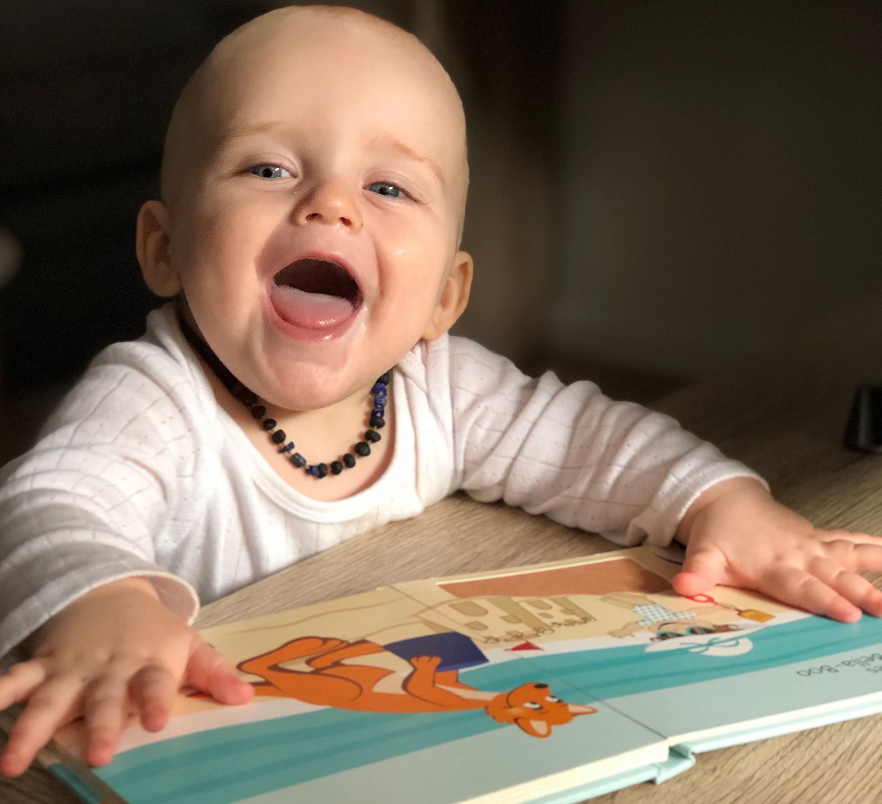 Baby reading a book. Baby open mouth